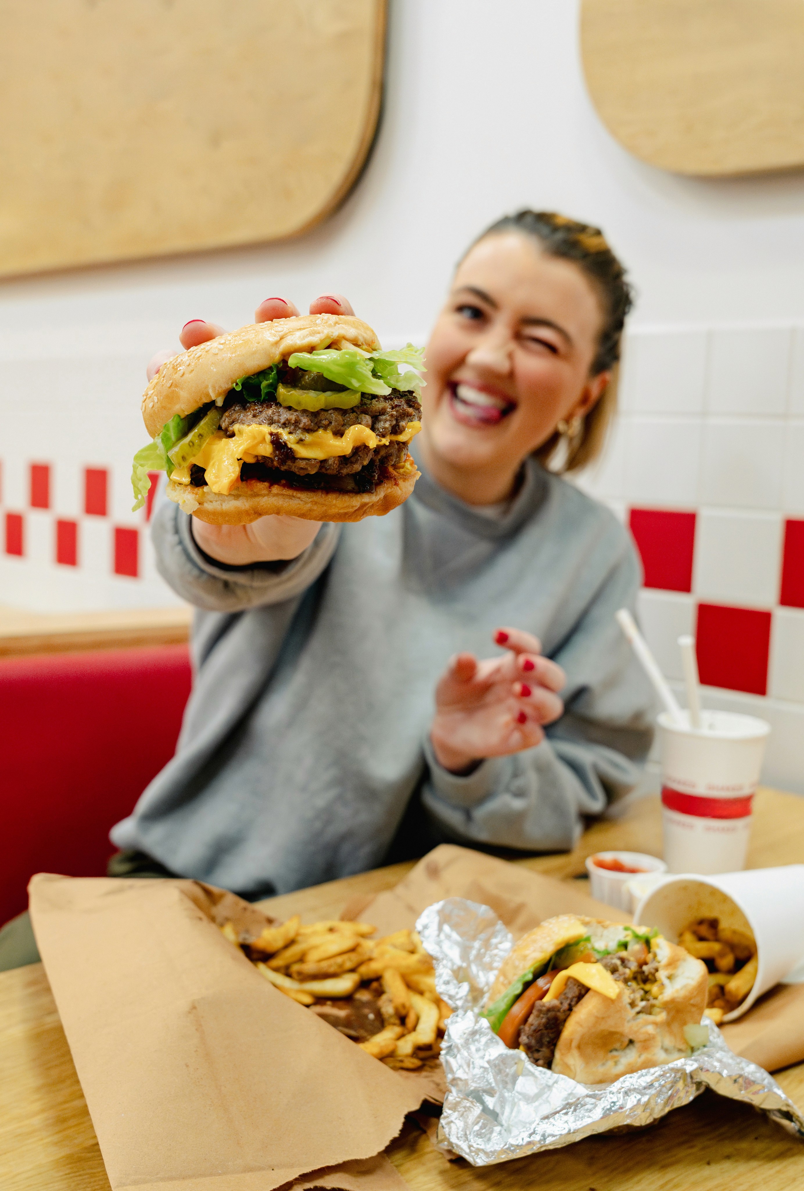selective focus photography of man holding eaten burger